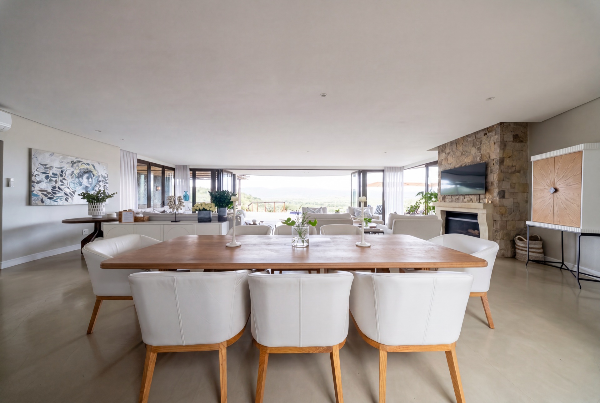 Long-table dining beneath the reed ceiling